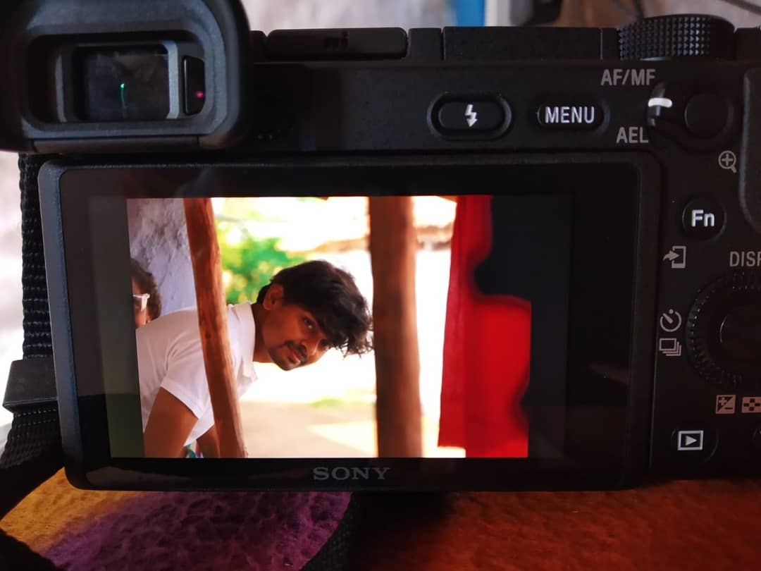 Sivaraj holding a camera