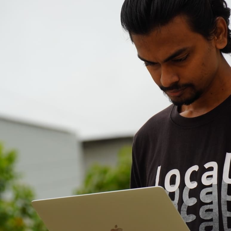 Sivaraj with a laptop in hand